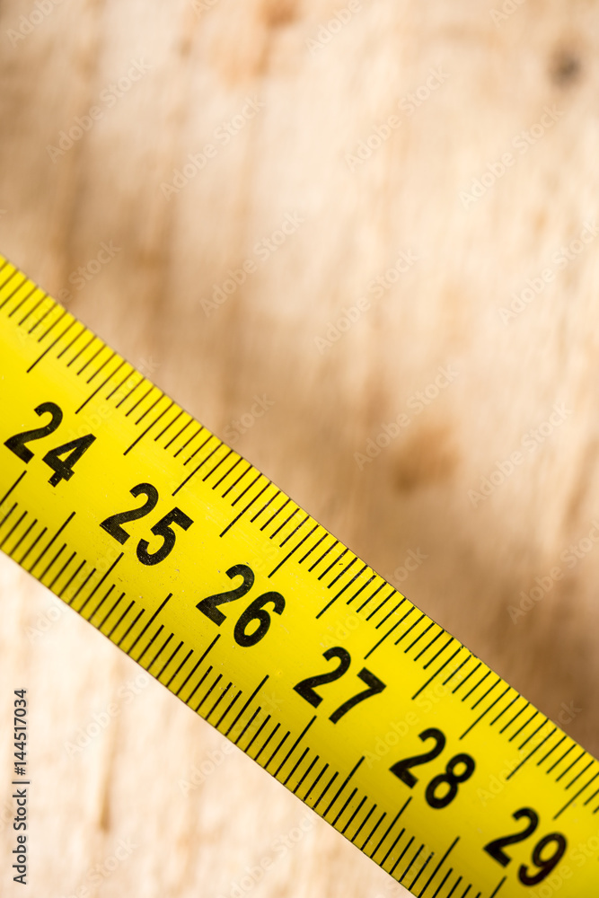 Yellow metal meter on the wooden planks background Yellow metal meter on the wooden planks background