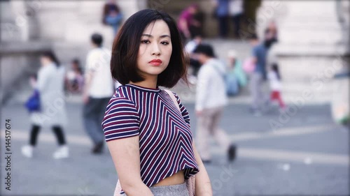 portrait of Serious asian woman looks menacingly at the camera photo