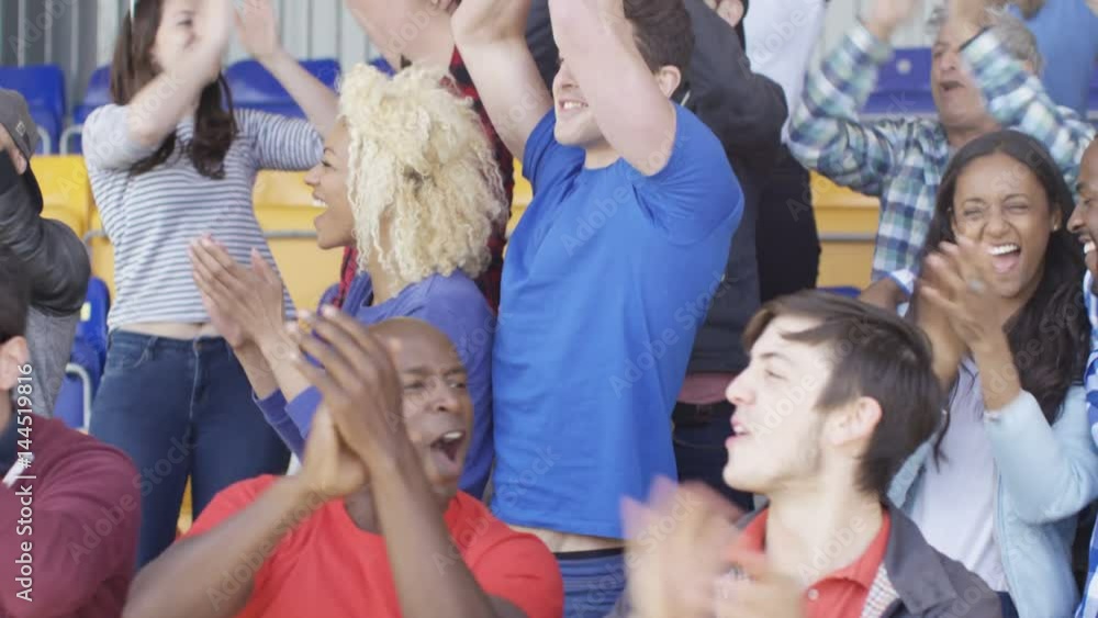 Excited sports fans at live game chanting & cheering for their team Excited sports fans at live game chanting & cheering for their team