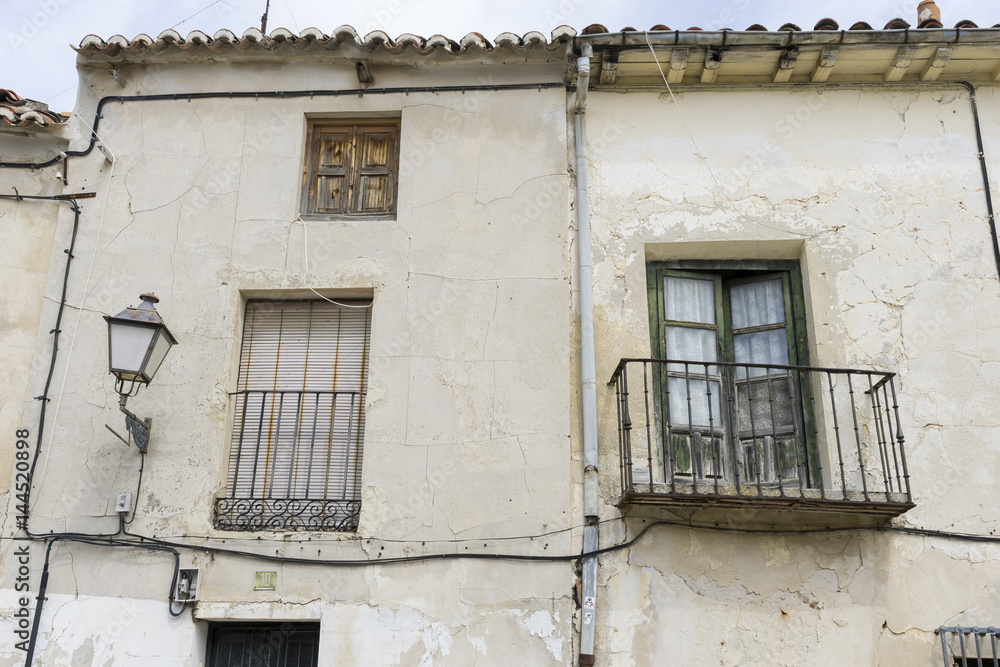 Old iron window with wooden edges on a Spanish street. Traditional architecture in spain