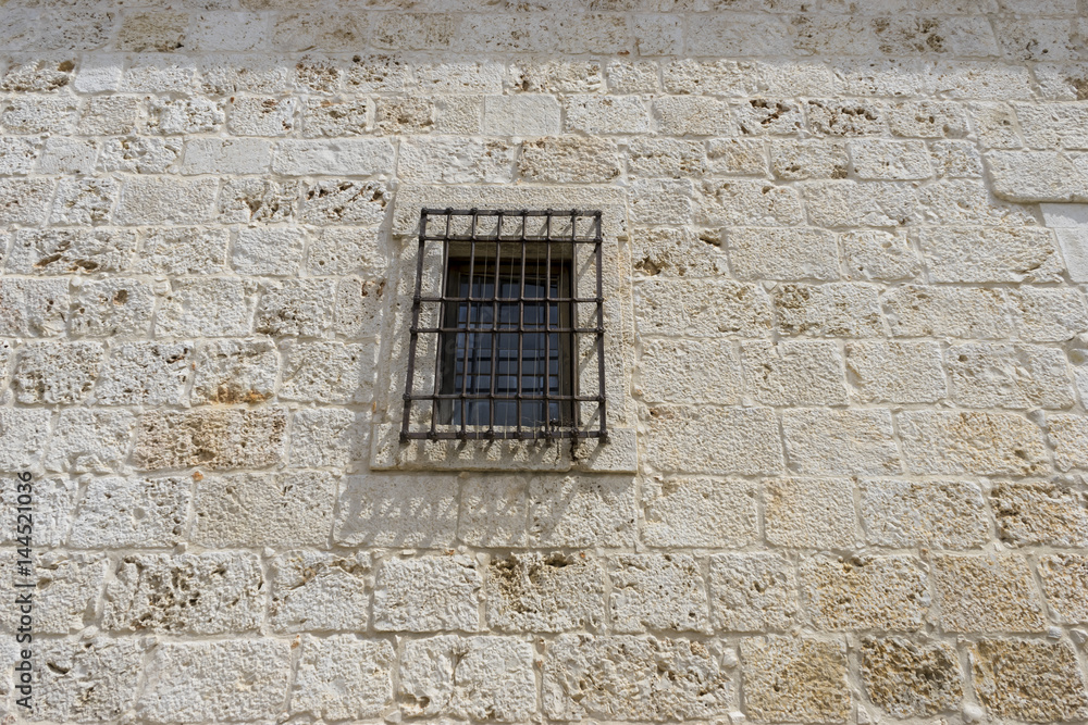 Old iron window with wooden edges on a Spanish street. Traditional architecture in spain