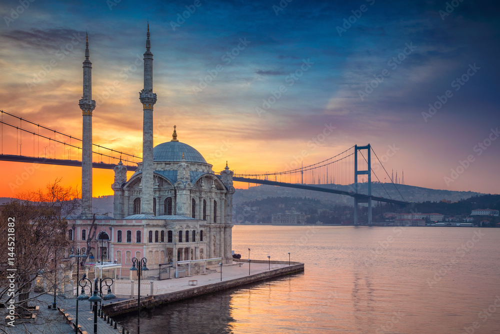 Fototapeta premium Stambuł. Obraz meczetu Ortakoy z mostem Bosfor w Stambule podczas pięknego wschodu słońca.