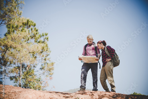 Man and woman Traveler with backpack on the mountain.