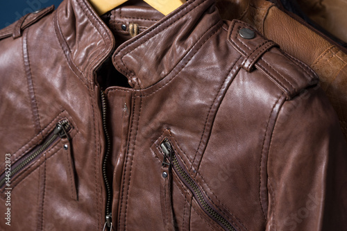 Brown textured leather jacket. Leather jacket macro details. Jacket zippers and pockets.