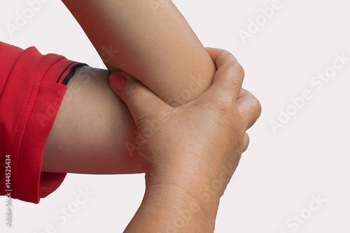Close up woman's hand holding her elbow . Elbow pain concept.