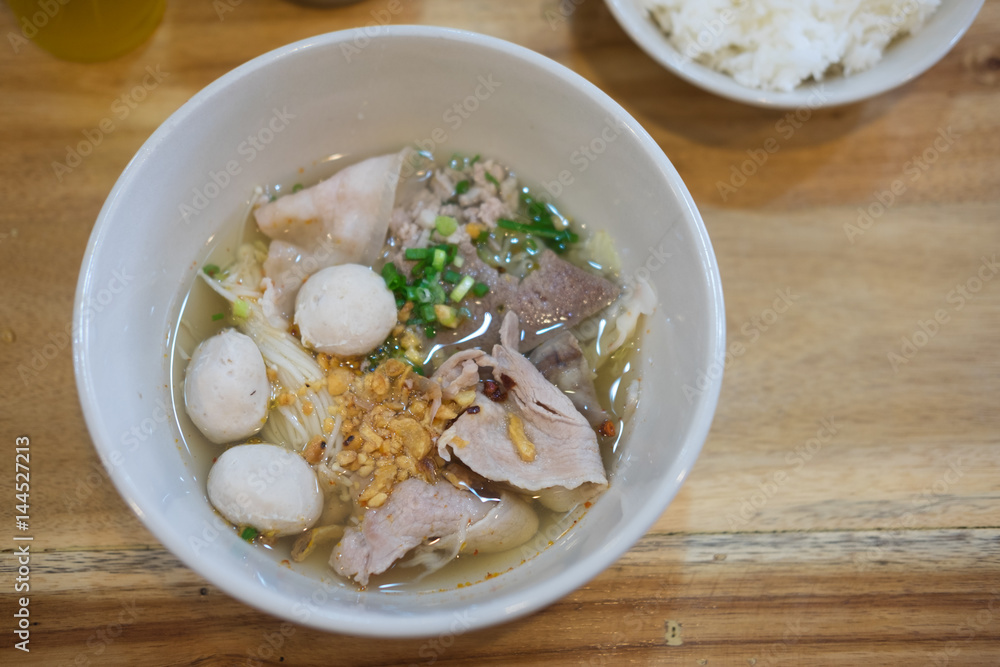 Noodle with pork ball and vegetables on wood table Noodle with pork ball and vegetables on wood table