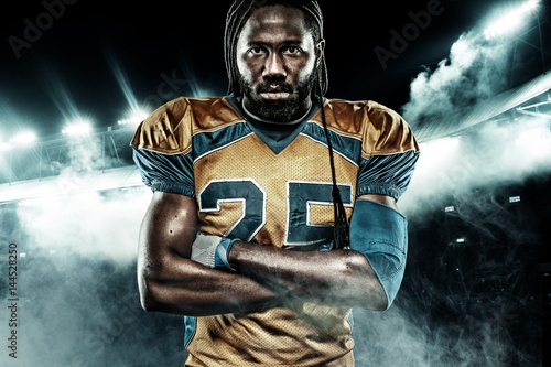 American football sportsman player on stadium with lights on background © Mike Orlov