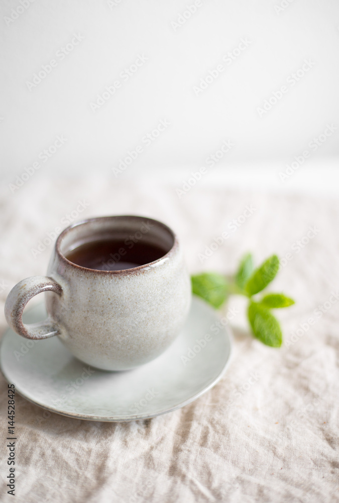 black tea with mint in old fashion rustic cup black tea with mint in old fashion rustic cup