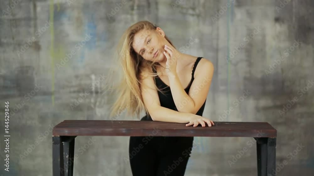 Young blonde girl posing in photo studio. Funny posing with his hair. Young blonde girl posing in photo studio. Funny posing with his hair.