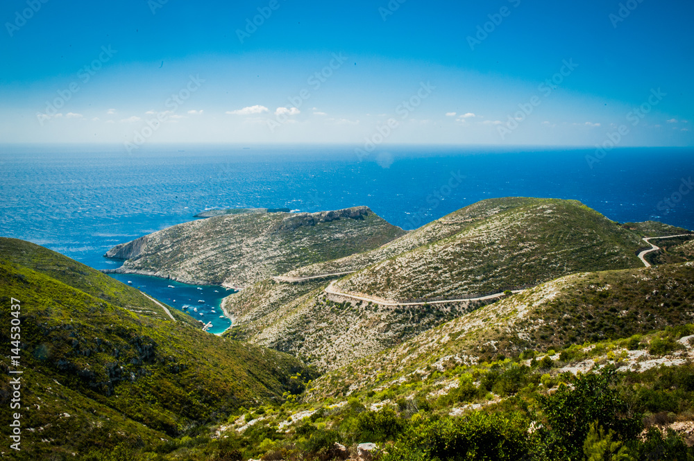Greece, Zakynthos, August 2016. Rocks, caves and blue water. View from observation point to panorama of island, bay and road