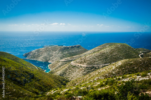 Obraz na płótnie Greece, Zakynthos, August 2016. Rocks, caves and blue water. View from observation point to panorama of island, bay and road w salonie