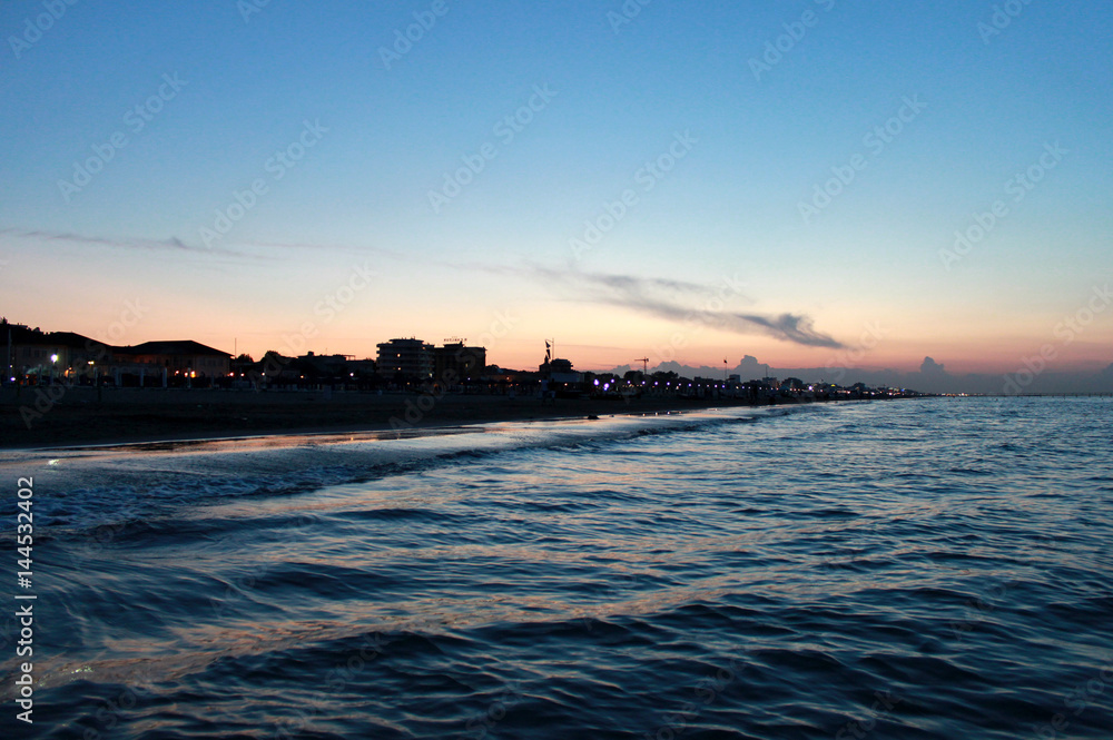 Obraz premium Italy. Emilia-Romagna. Rimini. Sea on blue pink sky background, horizontal view. Sunset.