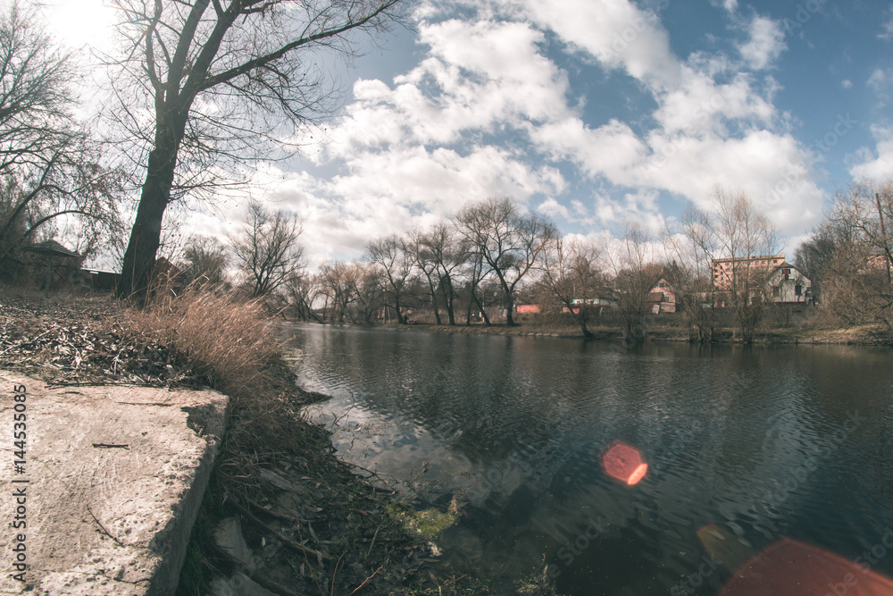 Fototapeta premium Spring landscape near the fisheye river.