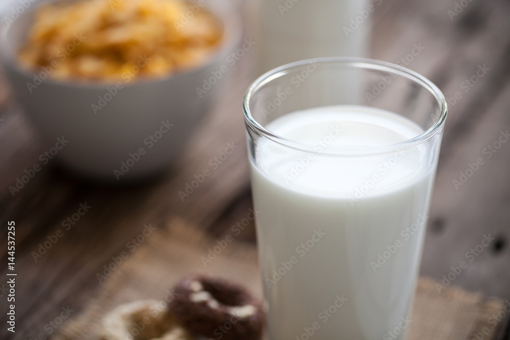 milk, cookies and bowl of cereal on wooden background milk, cookies and bowl of cereal on wooden background