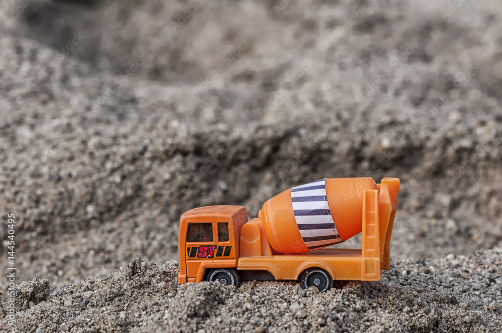 Mortar mixer, toy for kids in the sand. Shallow depth of field. Mortar mixer, toy for kids in the sand. Shallow depth of field.