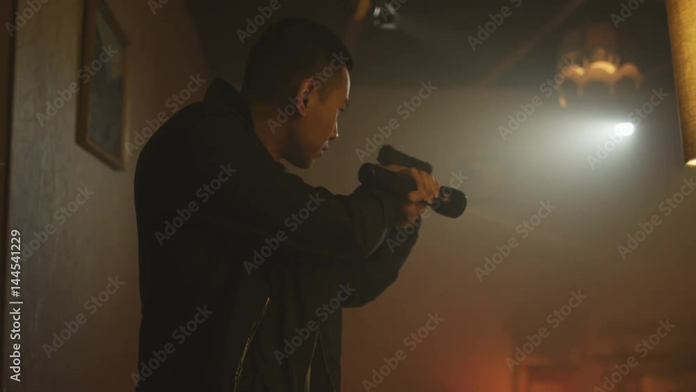 Police detectives with handguns & flashlights investigating crime scene