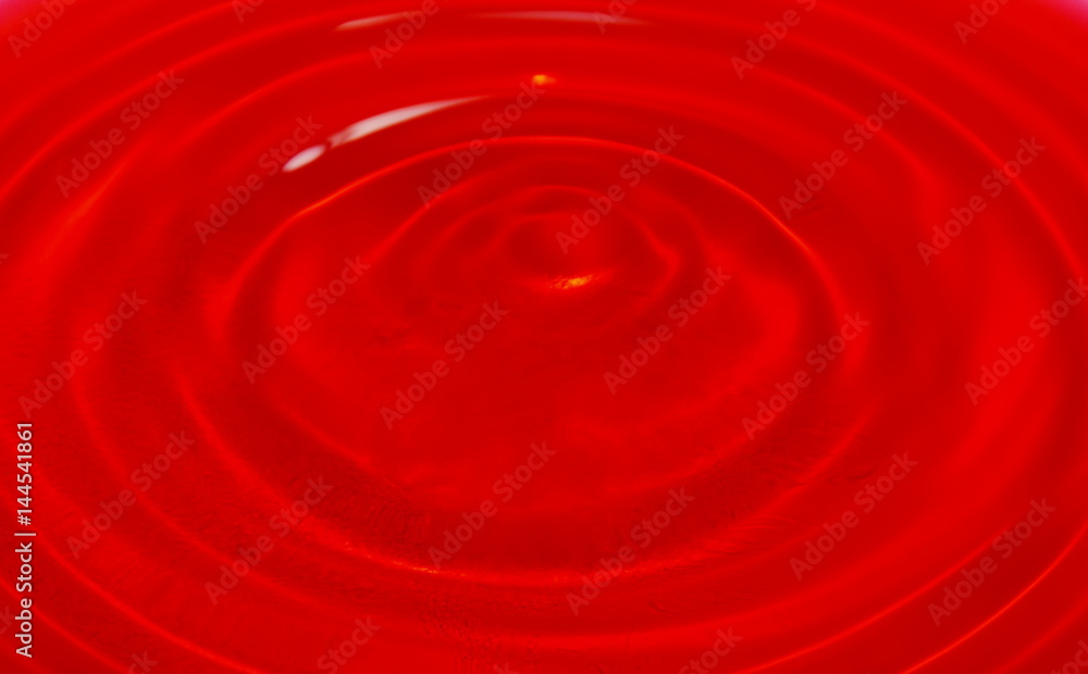 water dropping and splash in red background