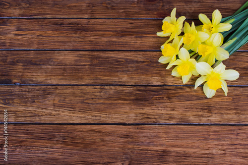 Yellow daffodils on a wooden background