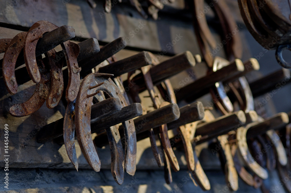 Brown rusty antique horseshoes in a barn Brown rusty antique horseshoes in a barn