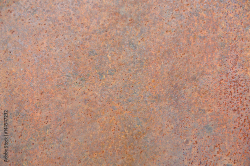 The rusty iron surface is old and rough.