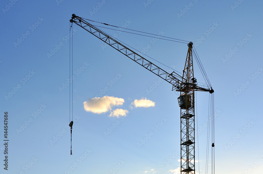 Large construction crane against the blue sky Large construction crane against the blue sky