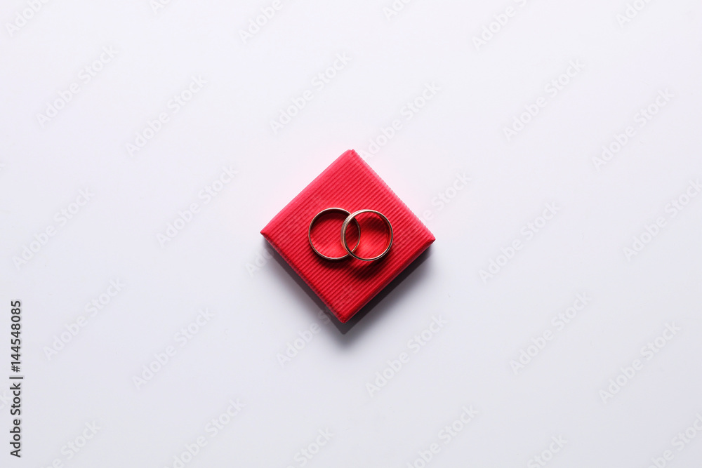 Gold wedding rings in a red box on a white background Gold wedding rings in a red box on a white background