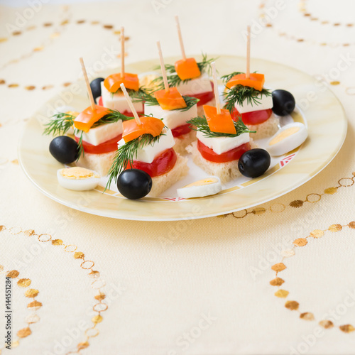 Cold snacks. Canapes of feta cheese and vegetables