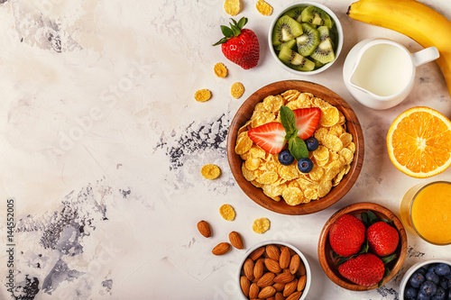 Healthy breakfast - bowl of corn flakes, berries and fruit