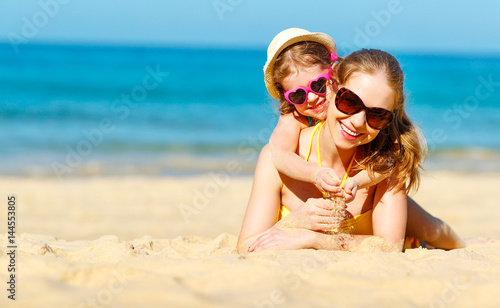 Happy family mother and child daughter  on beach in summer © JenkoAtaman