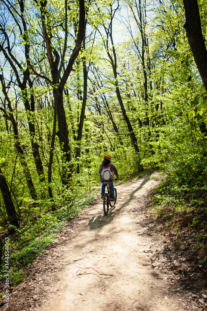 man ride mountain bike through forest man ride mountain bike through forest