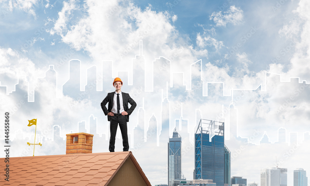 Engineer man standing on roof and looking away. Mixed media Engineer man standing on roof and looking away. Mixed media