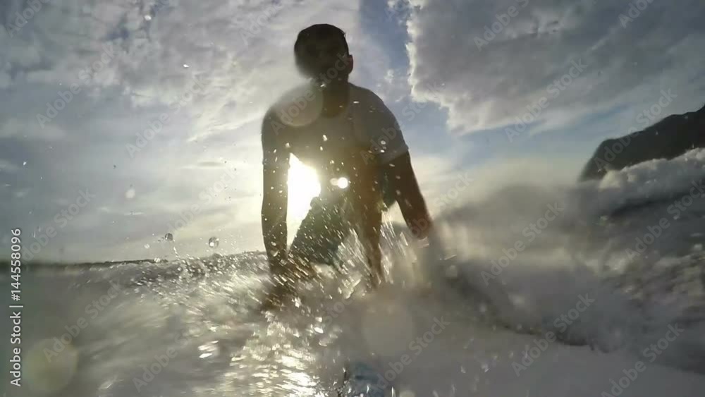 Slow motion of a surfer take off at sunset Slow motion of a surfer take off at sunset