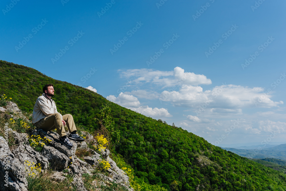 Meditating on a cliff with nature in background