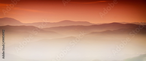 Mountain layer in morning sun ray and winter fog © Željko Radojko
