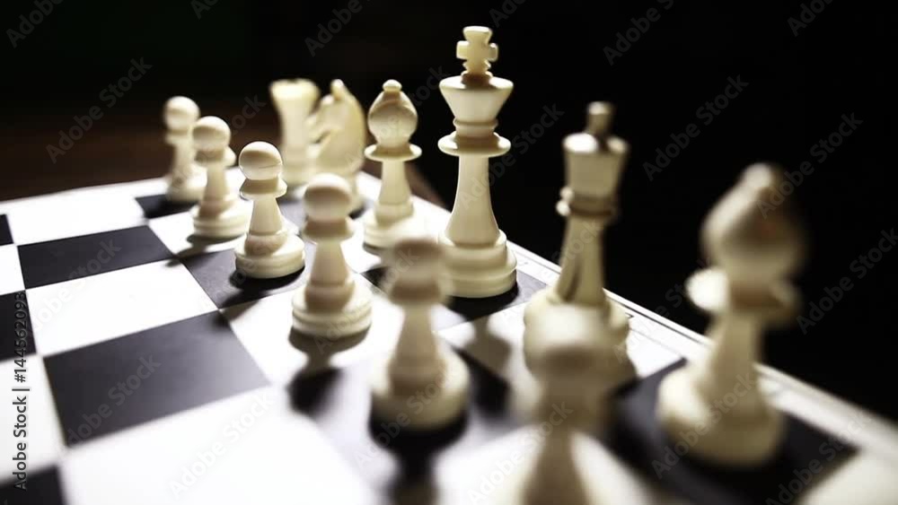 Dolly pull video of the white pieces on a chess board, with shallow depth of field. Dolly pull video of the white pieces on a chess board, with shallow depth of field.