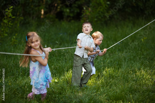 children pulling the rope outdoors