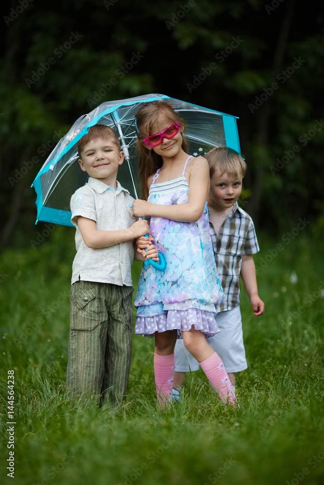Fototapeta premium happy children under umbrella in park