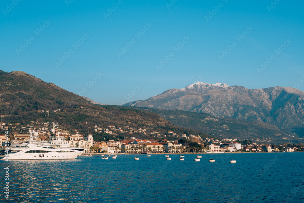 Lovcen in the snow. Snow on the mountain. View from Tivat. Waterfront Tivat in Montenegro.
