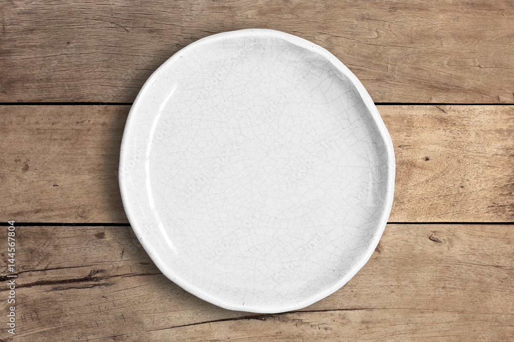Blank white dish on a wood background. Blank white dish on a wood background.