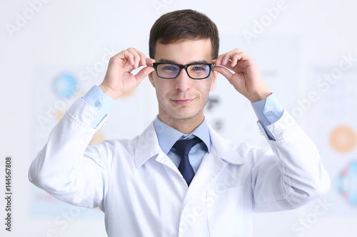 Handsome young ophthalmologist in clinic