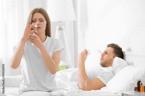 Young woman taking nasal dr...
