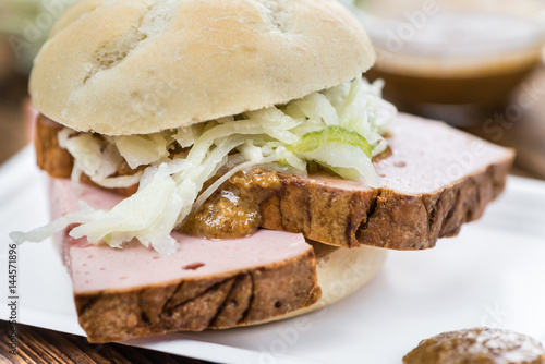 Portion of German Leberkaese on wooden background (selective focus) photo