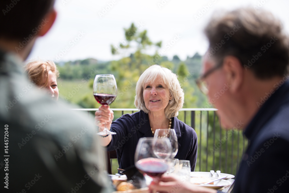 Senior woman raising a glass of wine Senior woman raising a glass of wine