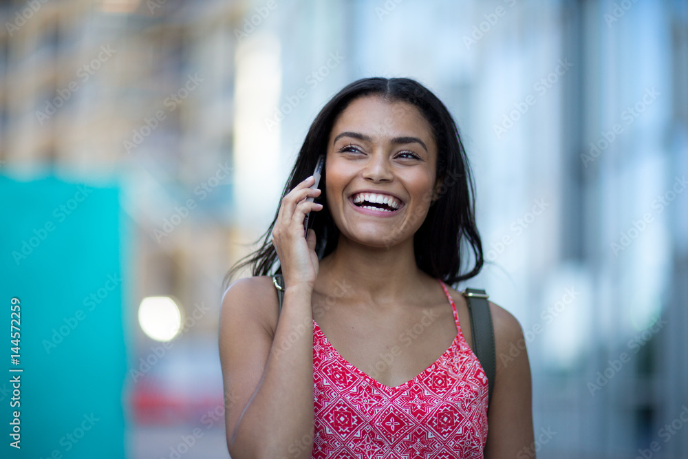 Young adult commuting and using smartphone