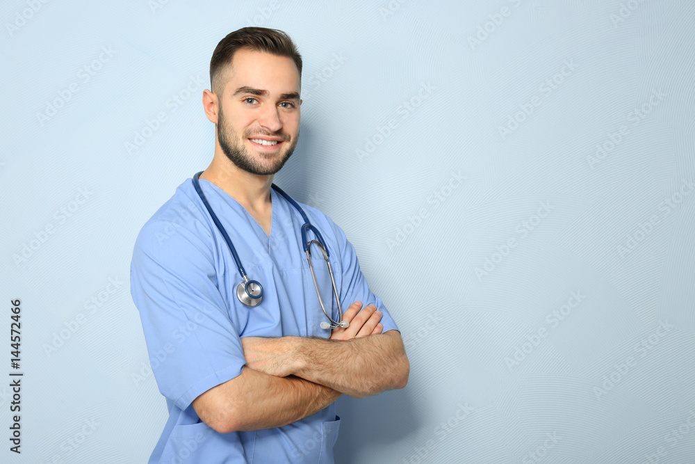 Young medical assistant with stethoscope on color background Young medical assistant with stethoscope on color background