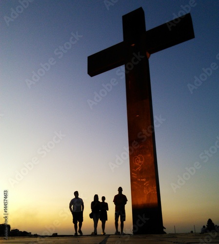 People walk by a cross sign in Praça do Papa (Pope's square) in Belo Horizonte, Brazil. In this place the Pope John Paul II made a celebration in the 80's