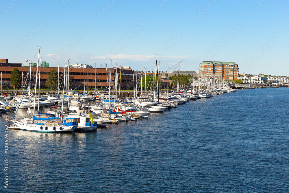 Boston city harbor in summer, USA. Yachts moored at docks of Charles River harbor.