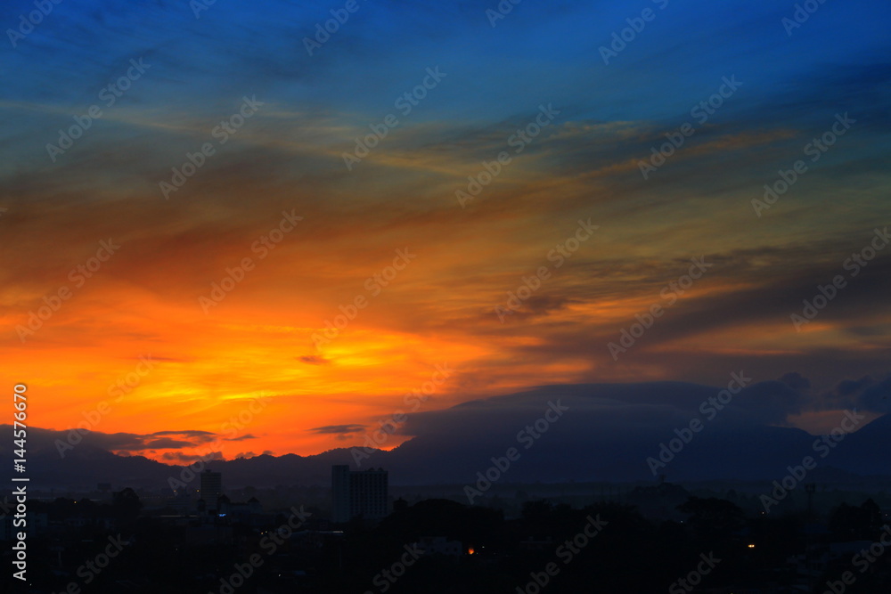 sunrise  in sky beautiful colorful before dawn nature landscape with city silhouette