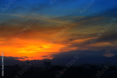 sunrise  in sky beautiful colorful before dawn nature landscape with city silhouette © pramot48
