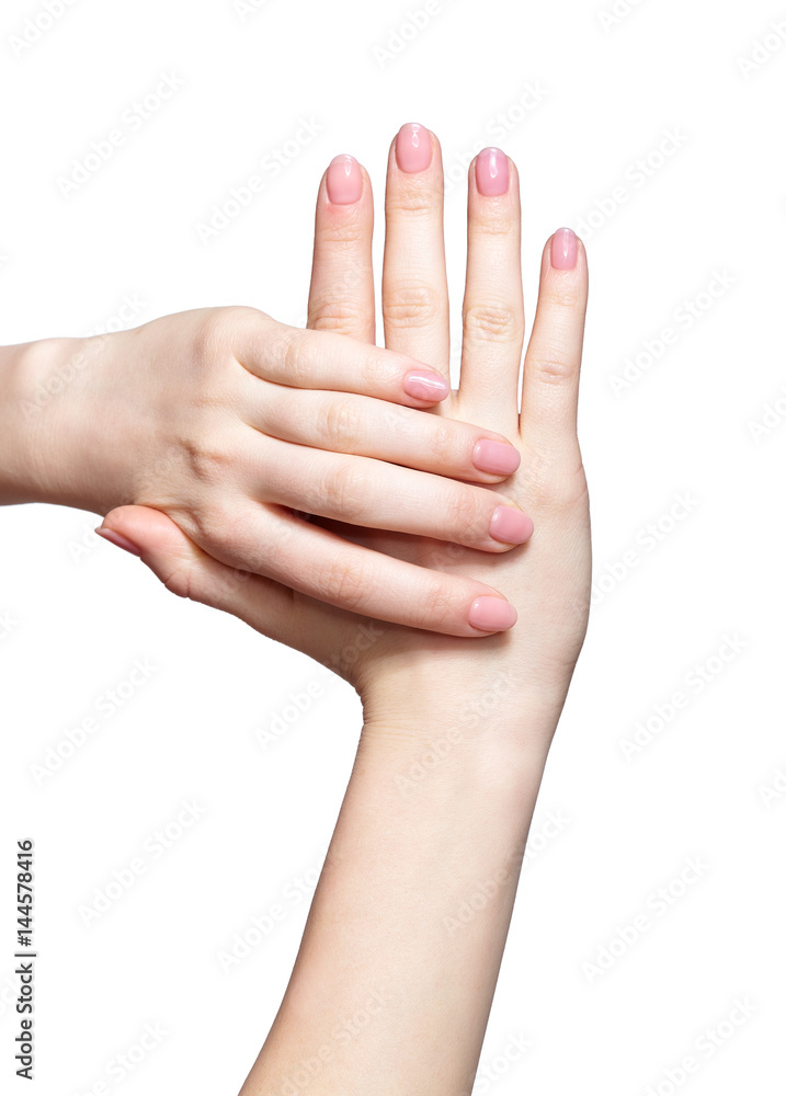Female hands with woman's professional natursl pink nails manicure on white Female hands with woman's professional natursl pink nails manicure on white